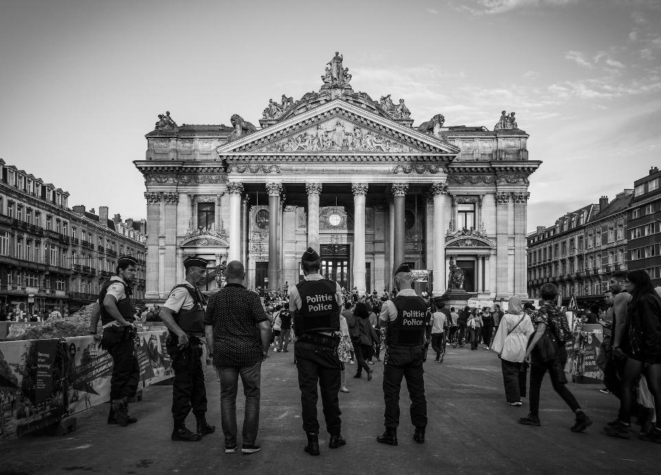 grayscale photography of people standing near building